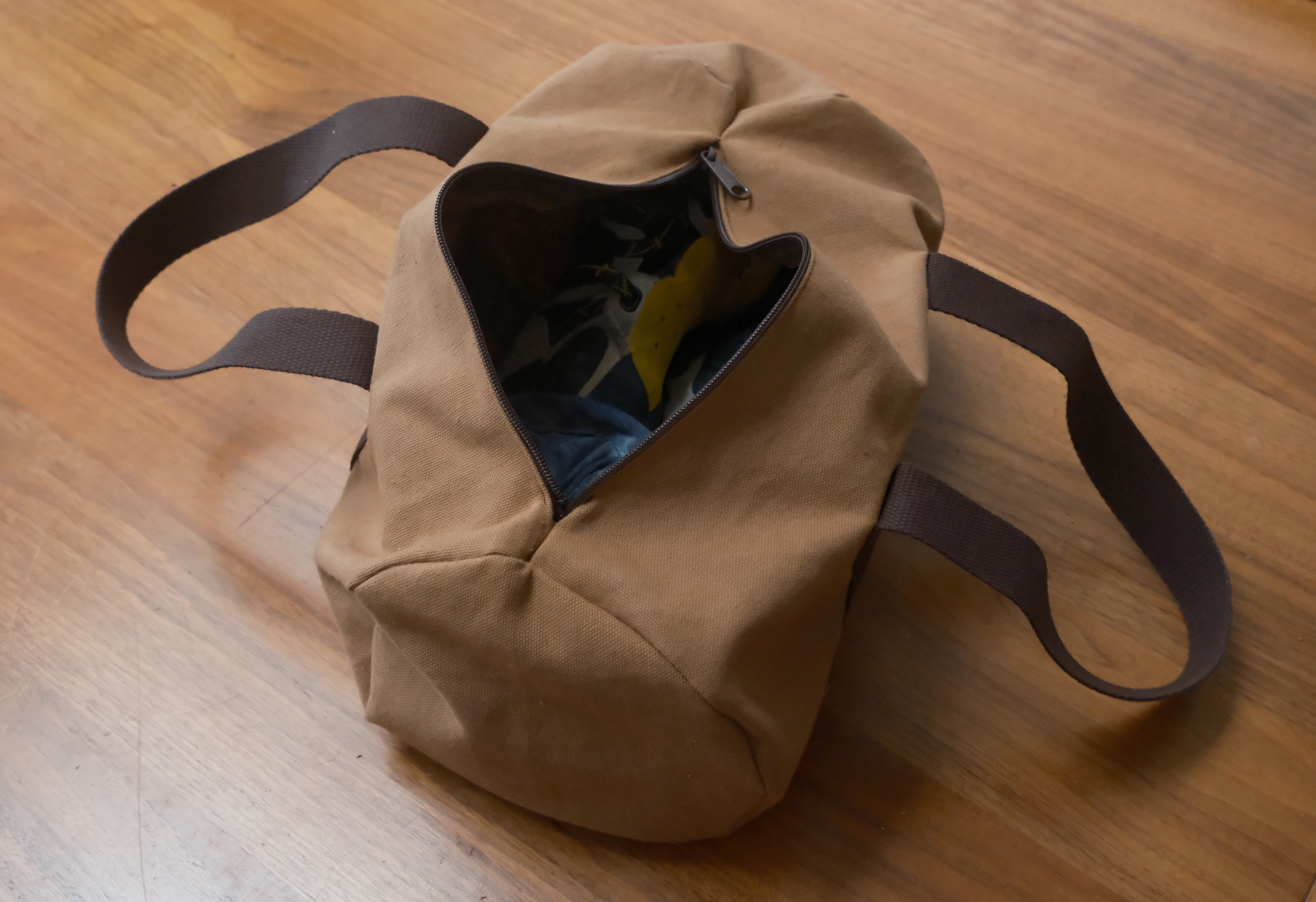 The bag unzipped with shoes in it